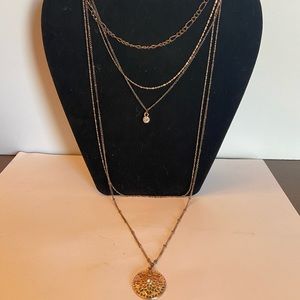 Long multi chain necklace with clear rhinestone drop pendant & goldtone pendant